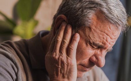 Stressed, unhappy man with severe earache mobile image